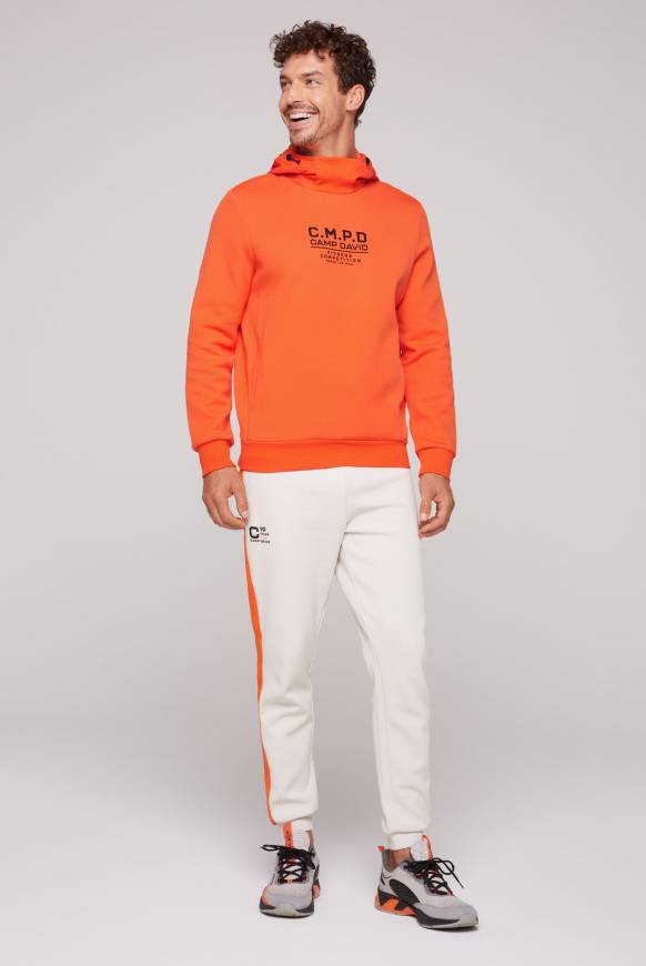 Soccx Hoodie im Materialmix mit Artwork und Rückentasche signal orange Begrenzte Freigabe